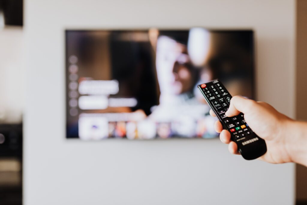 A Person Using a TV Remote 