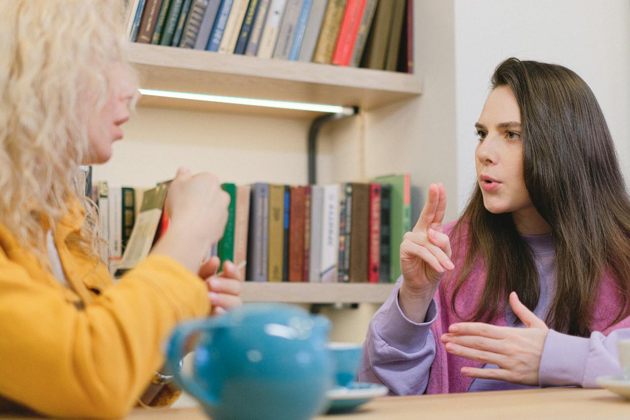 two women having a conversation using sign language